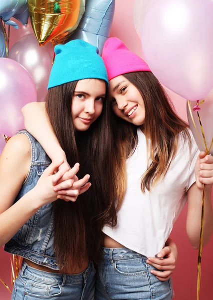 Beautiful girls with air balloons on pink background — Stock Photo, Image