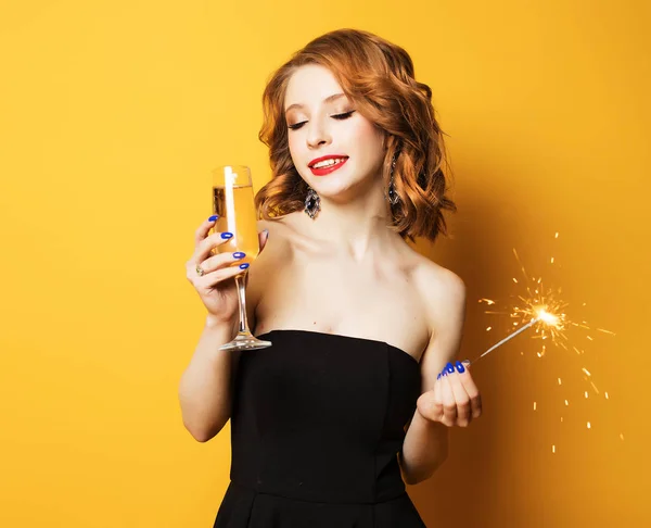 Attractive woman holding glass with champagne and sparkle — Stock Photo, Image