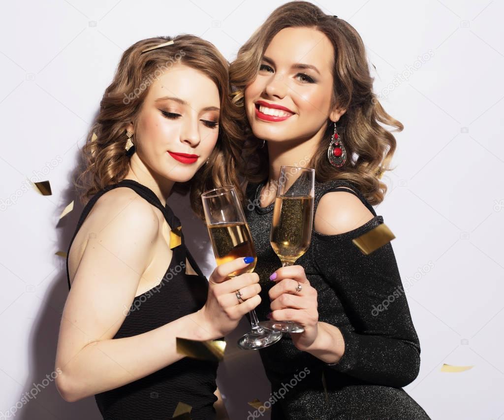 Couple of Two Rich Women Laughing with Crystal of Champagne. Luxury. Party time.