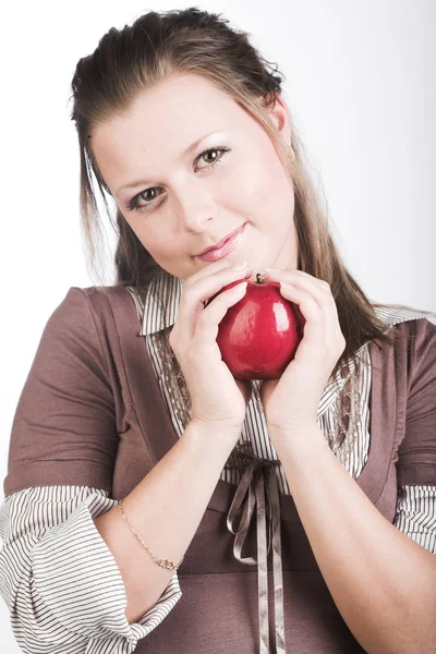 Young smiling woman with red apple. Royalty Free Stock Photos