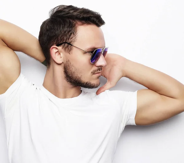 Young man in smart wear, wearing fashion sunglasses against whit — Stock Photo, Image