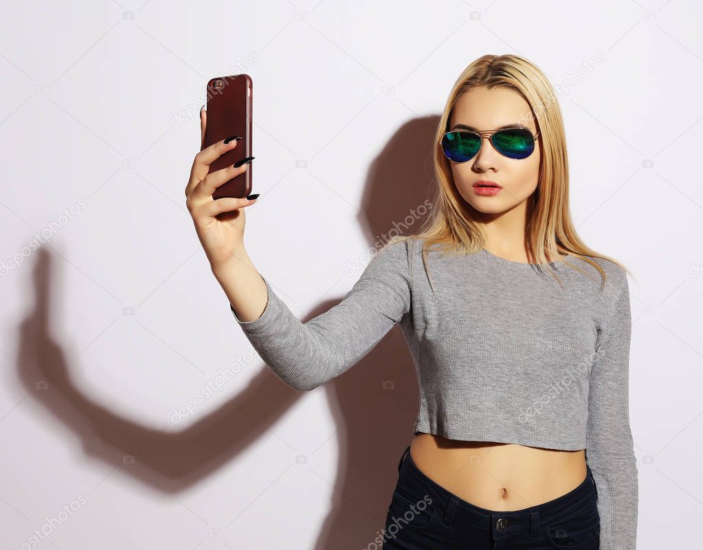 woman making selfie photo on smartphone isolated on a white bac