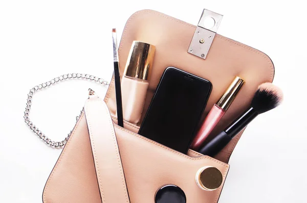 Flat lay of pink leather woman bag open out with cosmetics, acce — Stock Photo, Image