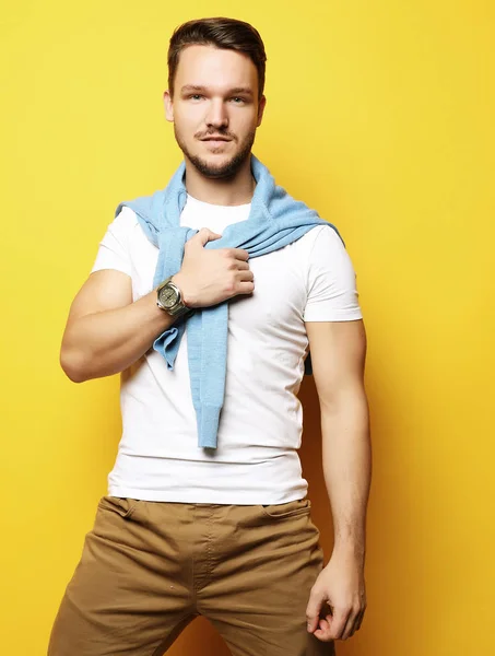 Young man in smart casual wear looking at camera over yellow bac — Stock Photo, Image