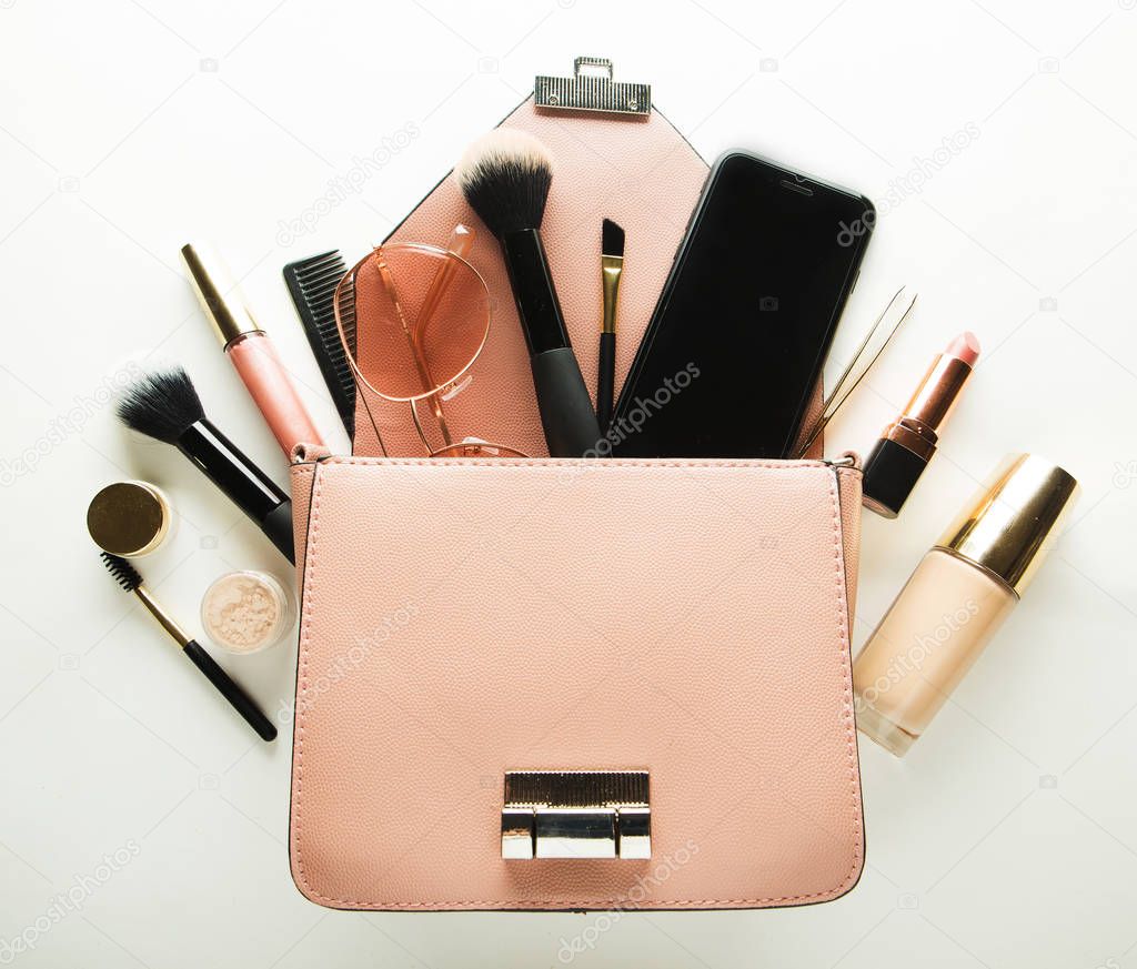 Makeup products with cosmetic bag on white  background