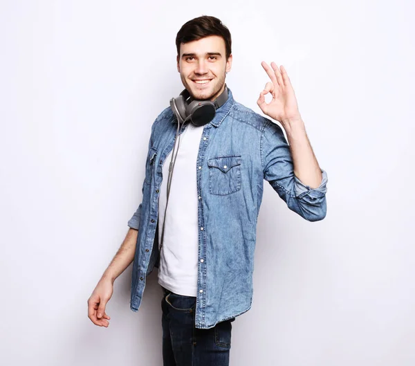 Portrait of a cheerful young man showing okay — Stock Photo, Image