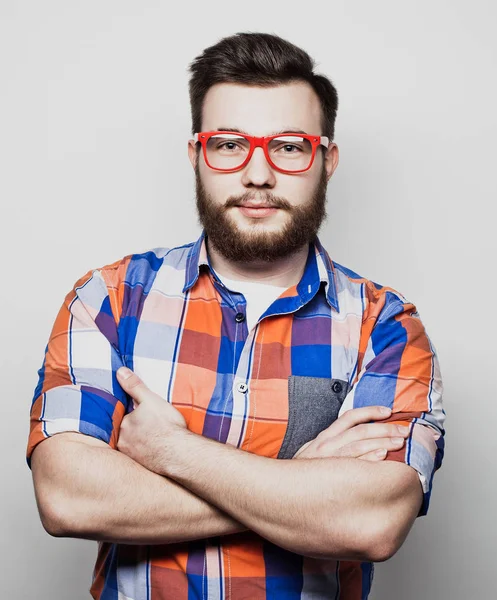 Lifestyle and people concept: Young bearded guy crossing his arms over white background — Stock Photo, Image
