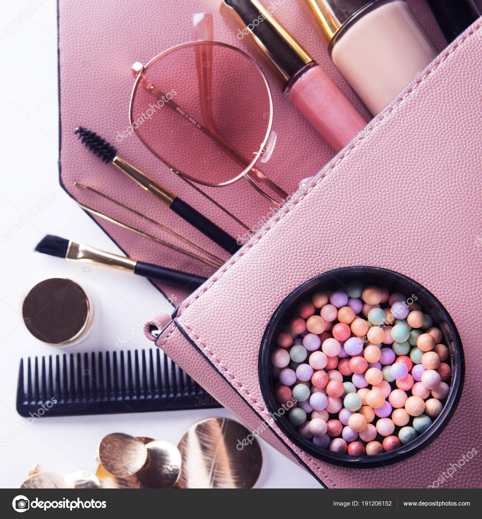 Makeup products with cosmetic bag on white background