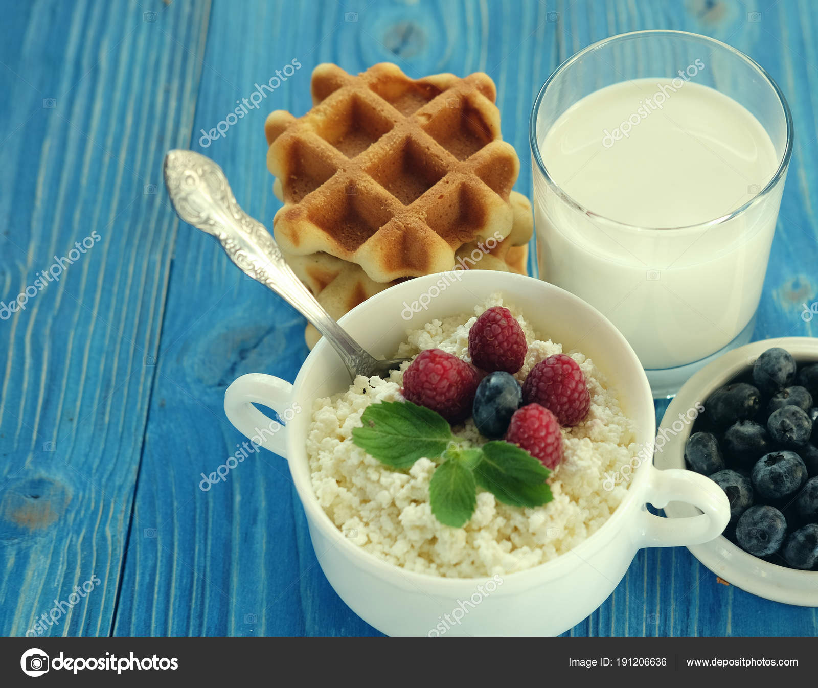 Cottage Cheese With Berries Waffles And Milk On A Wooden Blue
