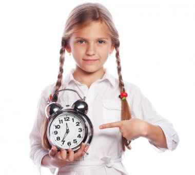 Beyaz arka plan üzerinde izole ayakta neşeli küçük kız çocuk. Kamera için çalar saat gösteren arıyorsunuz. Eğitim kavramı.