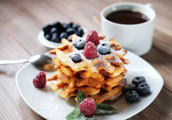 Waffles with  berries on a white plate and coffee, close up. — Stock Photo, Image