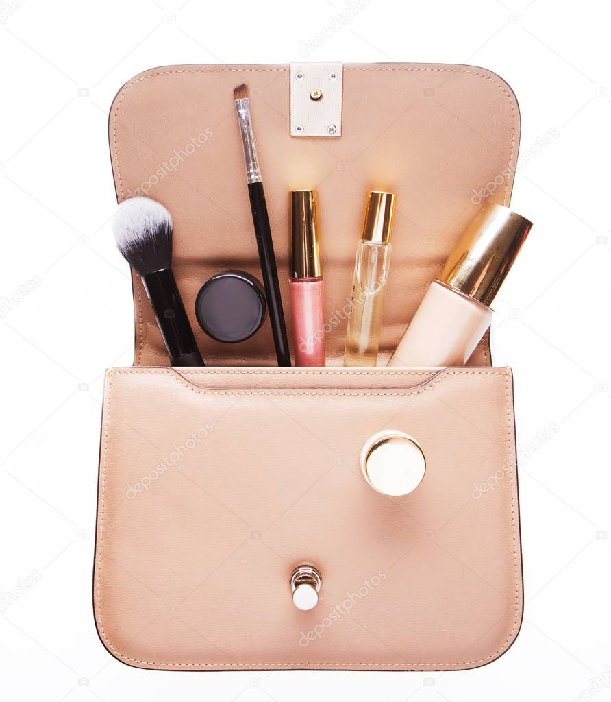 Makeup products with cosmetic bag on white  background