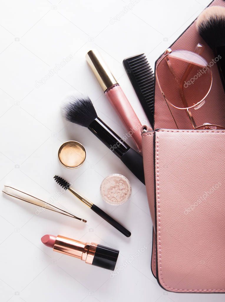 Makeup products with cosmetic bag on white  background