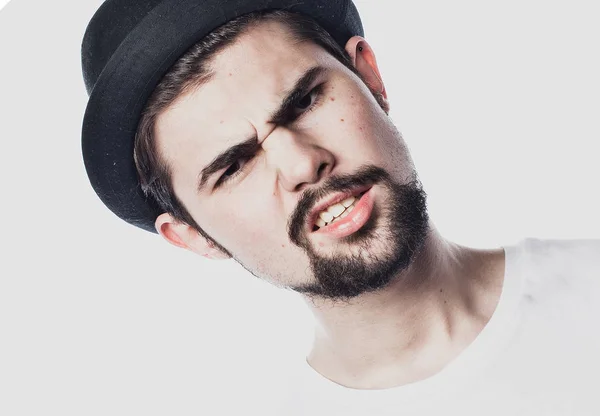 Portrait of bearded guy wearing black hat with unhappy expression on face — Stock Photo, Image