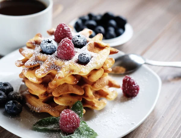 Waffles with  berries on a white plate and coffee, close up. — Stock Photo, Image