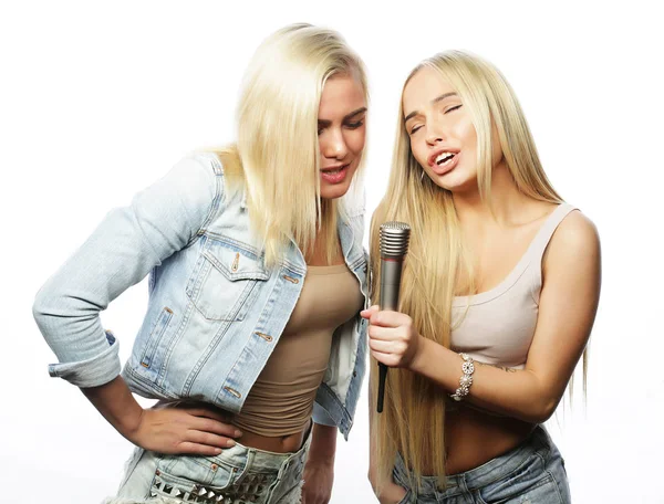 Life style, happiness, emotional and people concept: beauty hipster girls with a microphone singing and having fun over white background — Stock Photo, Image