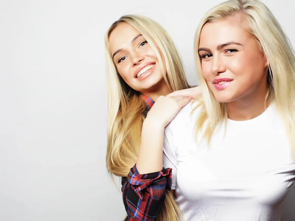 Estilo de vida y concepto de la gente: Dos amigas jóvenes de pie juntas y divirtiéndose. —  Fotos de Stock