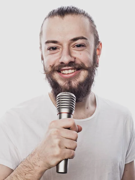 The entertainer. Young  talking man holding microphone, Isolated on white background. — Stock Photo, Image