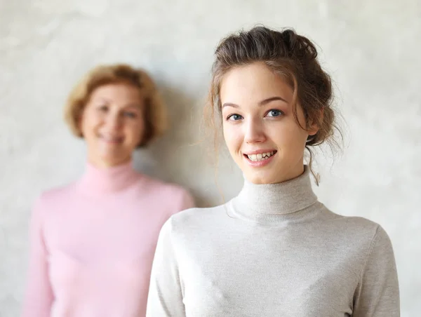 Happy young woman and her mother at home — Stock Photo, Image