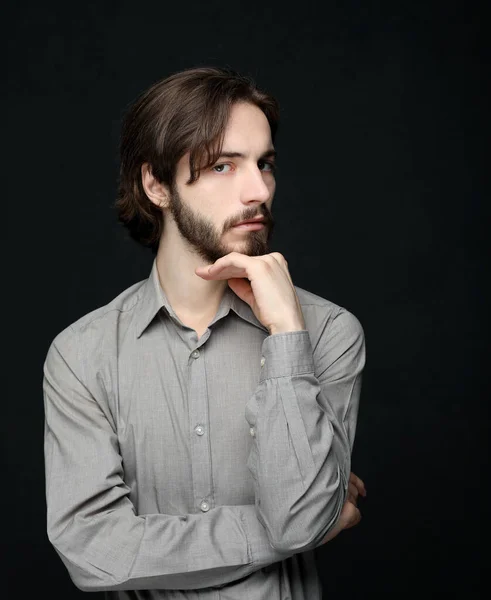 Unhappy man touching his forehead over black background — Stock Photo, Image