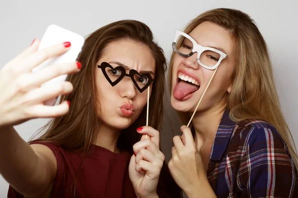 Lifestyle, party and people concept: two stylish sexy hipster girls best friends ready for party, over white background — Stock Photo, Image