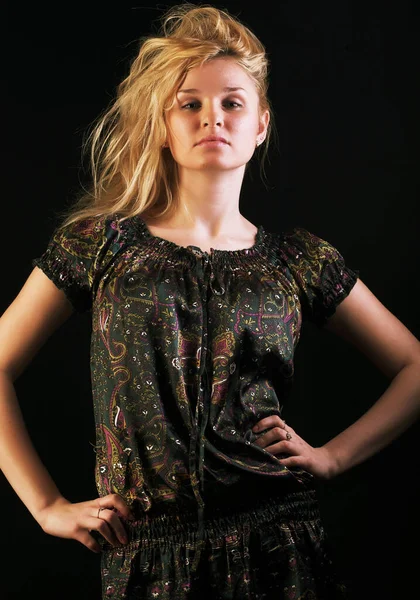 Young fashion model posing over black background — Stock Photo, Image