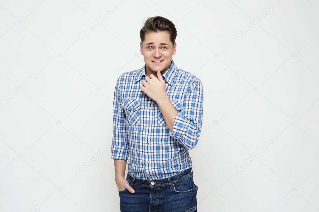 lifestyle and people concept: Portrait of a smart young man wearing casual standing against white background