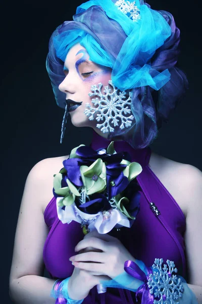 Woman with creative make up holding a bouquet of jewelry — Stock Photo, Image