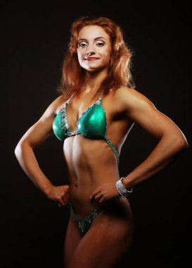 Siyah arka planda bikinili sarışın kadın.