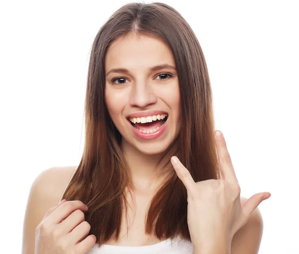 Happy woman poiting finger up at copyspace isolated on a white — Stock Photo, Image