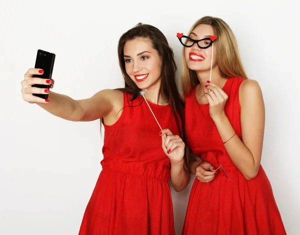 Zwei Frauen in rotem Kleid machen Selfie — Stockfoto