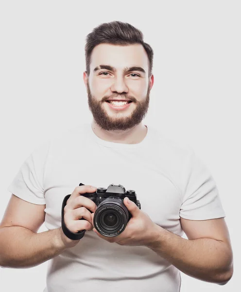 Young bearded photographer taking pictures with digital camera. — Stock Photo, Image