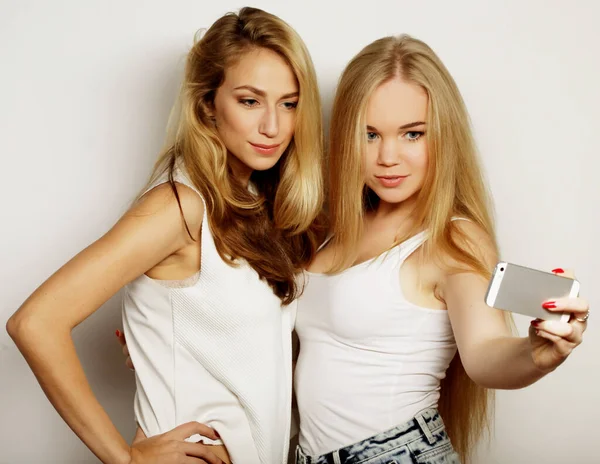 Duas jovens mulheres tomando selfie com telefone celular — Fotografia de Stock