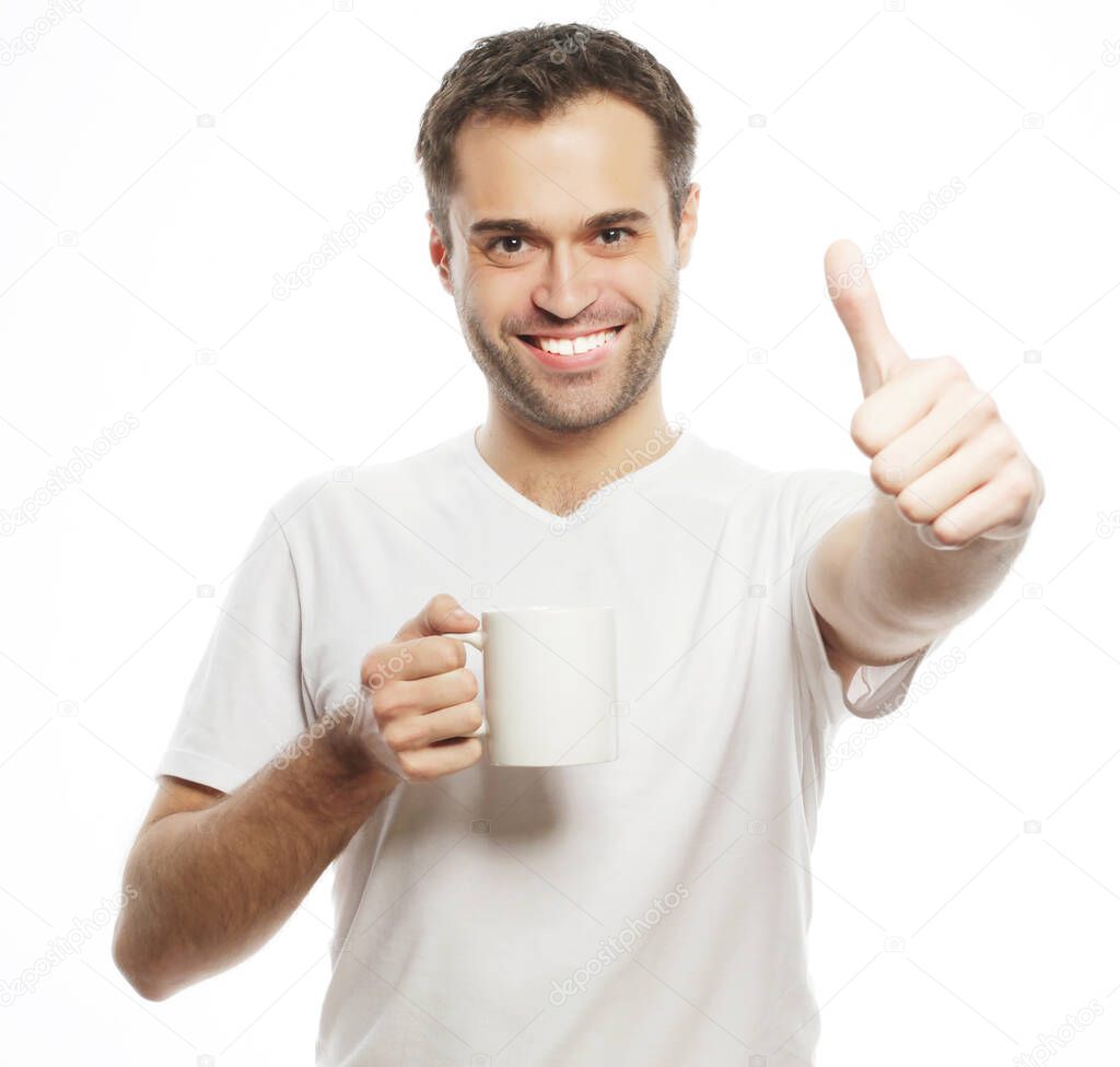 man holding white cup with coffee