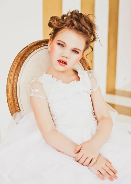 Little girl with blond hair wearing white dress. — Stock Photo, Image