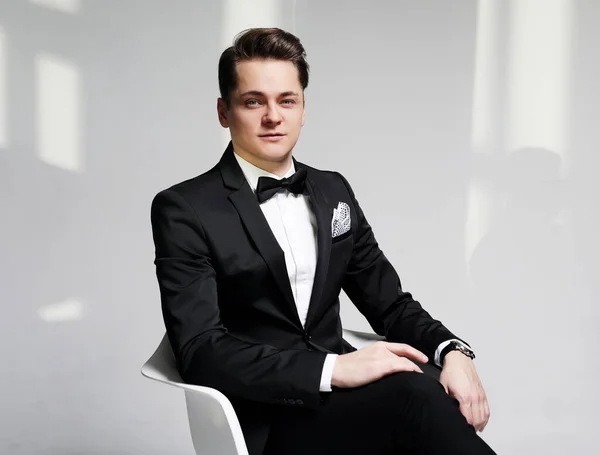 Portrait of handsome stylish man in elegant black suit — Stock Photo, Image