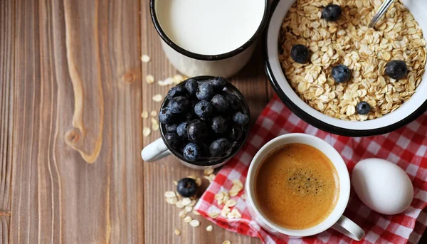 Ein gesundes Frühstück - Haferbrei, gekochtes Ei, Milch, frische Beeren und Kaffee. Ein toller Start in einen neuen Tag. — Stockfoto