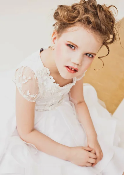 Little girl with blond hair wearing white dress. — Stock Photo, Image