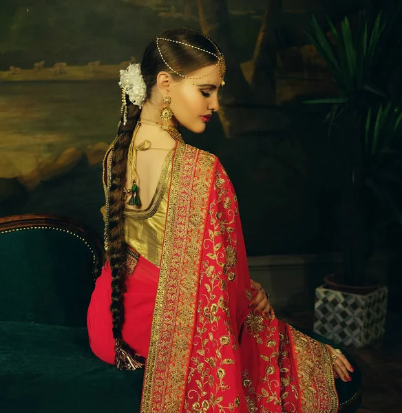 Retrato sonriente de hermosa chica india en casa. Modelo de mujer joven con conjunto de joyas de oro . — Foto de Stock