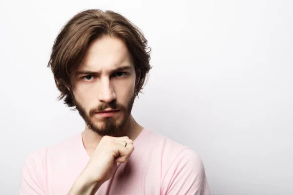 Portrait of young bearded man posing over white background, casual style — Stock Photo, Image