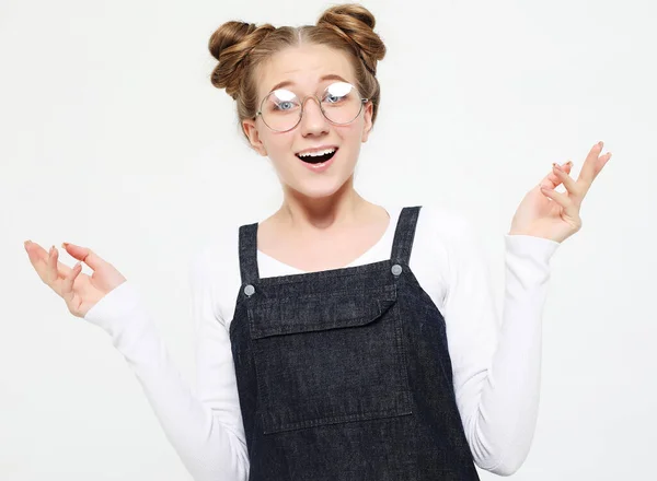 Retrato de uma jovem menina casual confuso encolhendo ombros isolados sobre fundo rosa — Fotografia de Stock