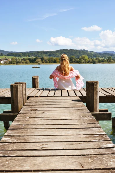 Girl on wooden pier — Stock Photo, Image