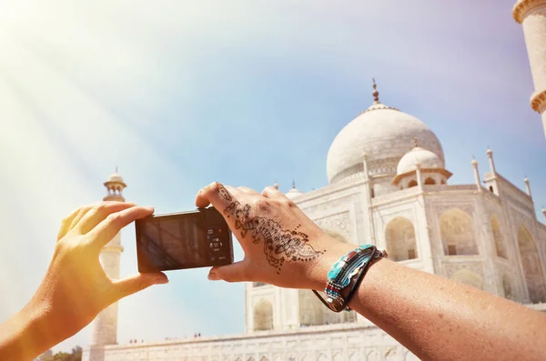 Person taking photo of Taj Mahal