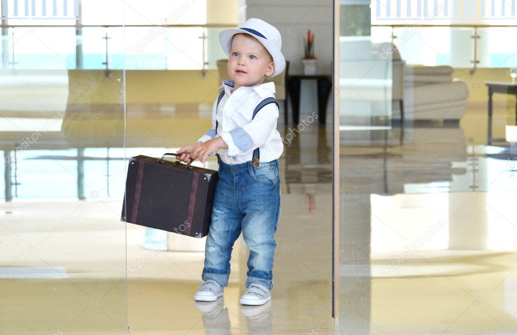 Toddler traveler with a suitcase