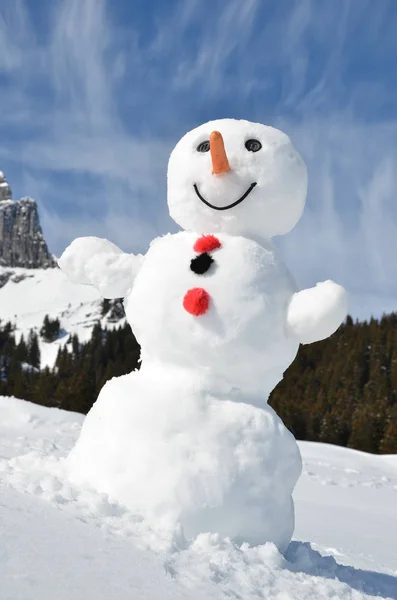 Funny snowman against Swiss Alps — Stock Photo, Image