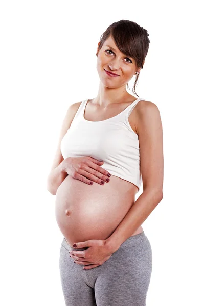 Pregnant woman caressing her belly over white background — Stock Photo, Image