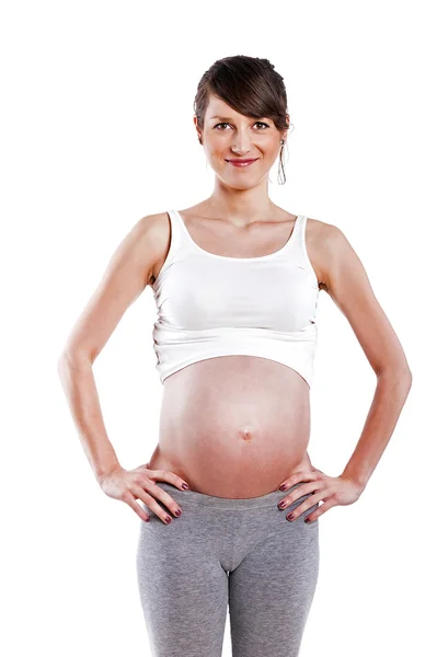 Zwanger vrouw strelen haar buik over witte achtergrond — Stockfoto