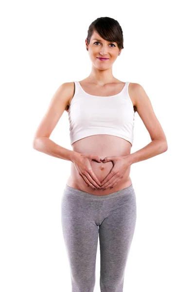 Vacker gravid kvinna, hjärta - isolerade under en vita backgrou — Stockfoto