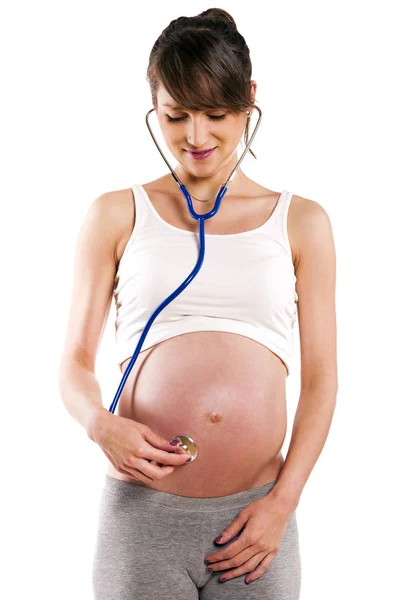 Pregnant woman listen with stethoscope her baby. Pregnant belly — Stock Photo, Image