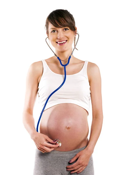 Pregnant woman listen with stethoscope her baby. Pregnant belly Stock Picture